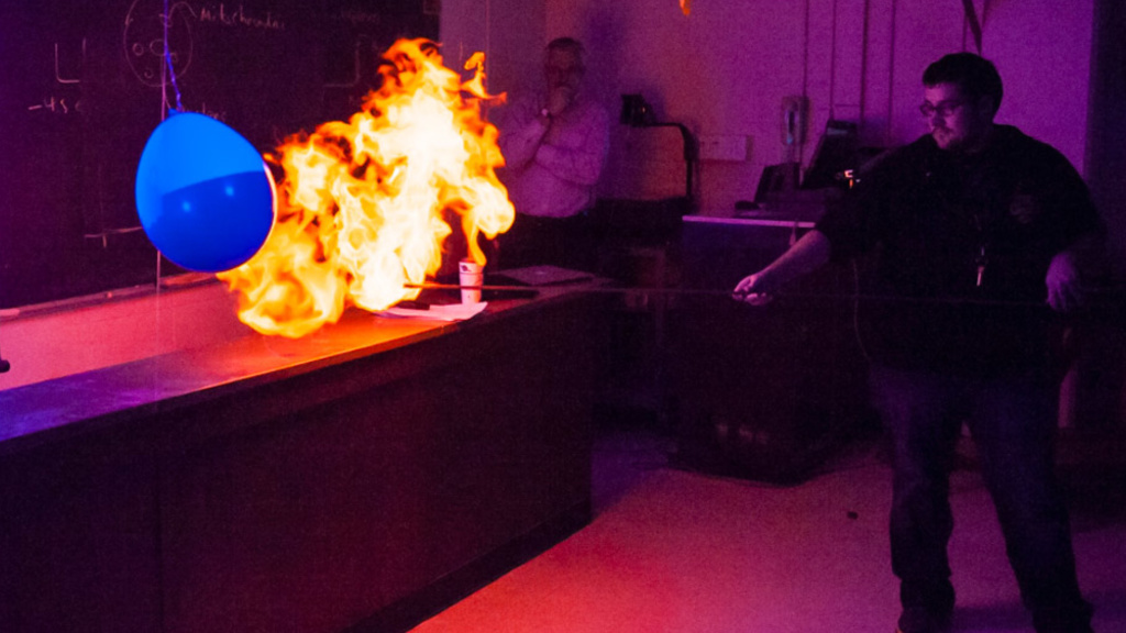 A student in General Astronomy ignites a fireball at the front of class